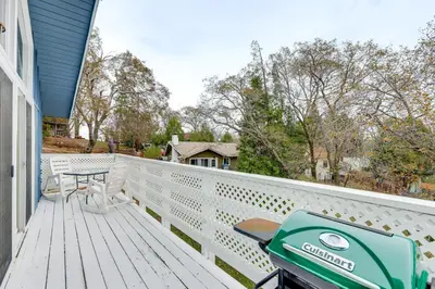 a porch with a green scooter parked on it at 2 Mi to Lake Arrowhead! Mtn-View Hideaway with Deck in Cedar Glen