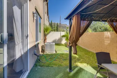 a patio with a table and an umbrella at Home Theater System and Gazebo Los Angeles Getaway! in San Fernando