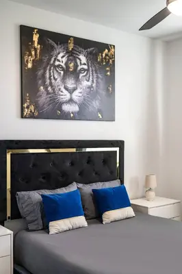 a bedroom with a bed with a picture of a tiger at Newly Remodeled 3BR Apt | Mins to Disney | Arcade in Placentia