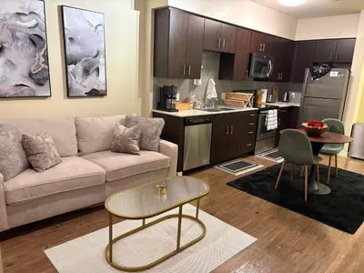 a living room with a couch and a kitchen at Luxurious precious mile in Los Angeles