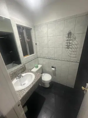 a bathroom with a sink and a toilet at Heritage Inn in Pomona