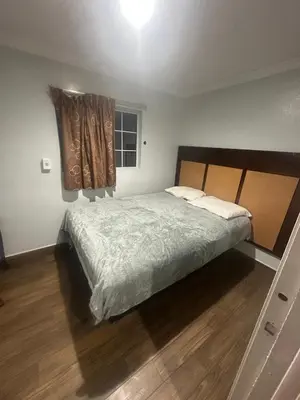 a bedroom with a large bed and a window at Heritage Inn in Pomona