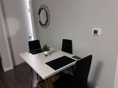 a white table with two chairs and a mirror at DTLA prime one bedroom steps away from Crypto in Los Angeles