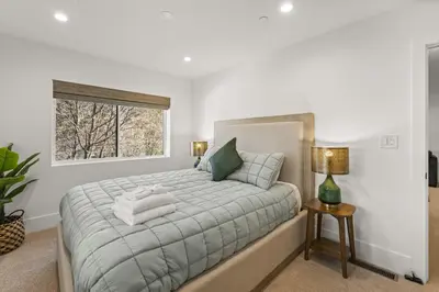 a bedroom with a bed with towels on it at Skyline Summit Lodge in Big Bear Lake