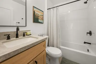 a bathroom with a sink and a toilet and a shower at Skyline Summit Lodge in Big Bear Lake