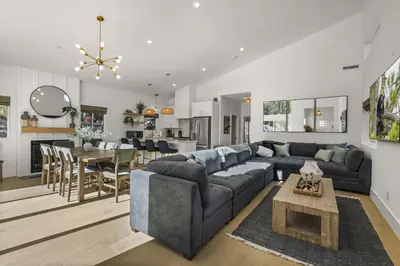a living room with a couch and a dining room at Skyline Summit Lodge in Big Bear Lake