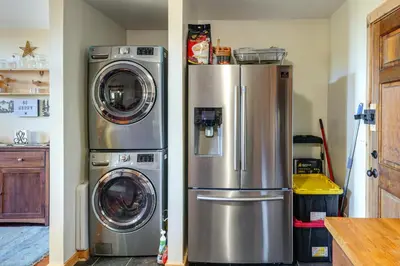 two refrigerators and a washer and dryer in a kitchen at PMC Mountainside Cabin Hit the Trails, Play Pool! in Pine Mountain Club