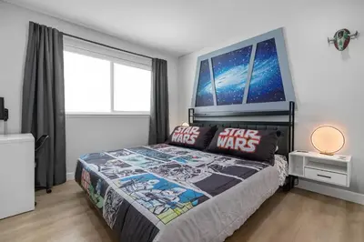 a bedroom with a star wars bed with a large window at Star Wars Retreat by OC Adventure Homes in Garden Grove