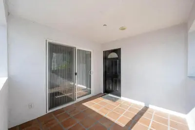 an empty room with a door and a balcony at Niagara Haven Unit 103 in Burbank