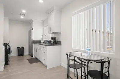 a kitchen with a table and two chairs and a counter at Niagara Haven Unit 103 in Burbank