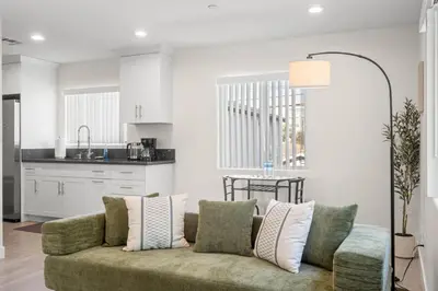 a living room with a couch and a kitchen at Niagara Haven Unit 103 in Burbank