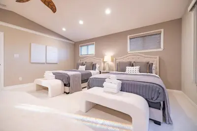 a bedroom with two beds and two seats at Marbella Lane - Charming 4BR Bungalo for Relaxing Retreat in Fullerton