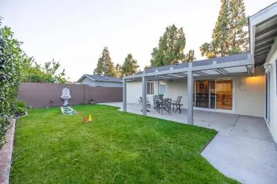 a backyard of a house with a grass yard at Marbella Lane - Charming 4BR Bungalo for Relaxing Retreat in Fullerton