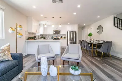 a living room with a couch and a table at Modern 4BR Stay Premium Beds & Full Kitchen in Burbank