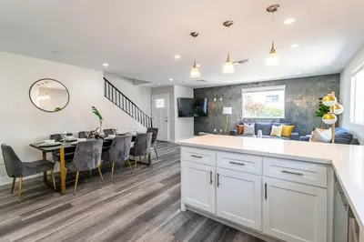 a kitchen and dining room with a table and chairs at Modern 4BR Stay Premium Beds & Full Kitchen in Burbank