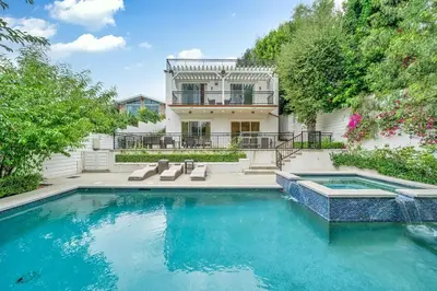 a swimming pool in front of a house at Modern Luxe Villa Pool Rooftop Paradise in Sherman Oaks