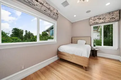 a bedroom with a bed and two windows at Modern Luxe Villa Pool Rooftop Paradise in Sherman Oaks