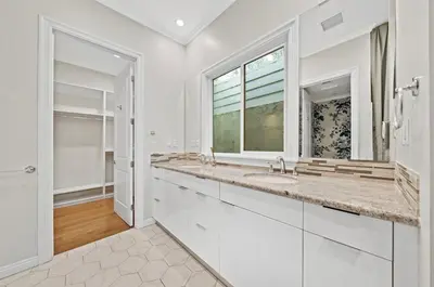 a white bathroom with two sinks and a window at Modern Luxe Villa Pool Rooftop Paradise in Sherman Oaks