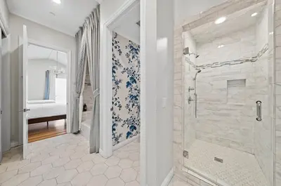 a bathroom with a walk in shower next to a glass door at Modern Luxe Villa Pool Rooftop Paradise in Sherman Oaks