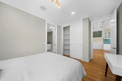 a white bedroom with a bed and a desk at Modern Luxe Villa Pool Rooftop Paradise in Sherman Oaks