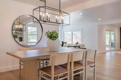 a dining room with a table and a mirror at Cozy Modern Haven w Soothing Ambience & Pool in Fullerton