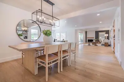 a dining room with a table and a mirror at Cozy Modern Haven w Soothing Ambience & Pool in Fullerton