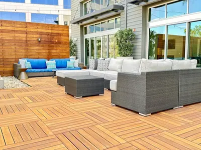 a patio with couches and chairs on a wooden floor at The Mandarin at Main Place - Free Disney Gift Gard in Orange