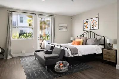 a bedroom with a bed and a chair and a couch at Casa Clementine - 10 min to SNA&Beach Plus Free Parking in Orange