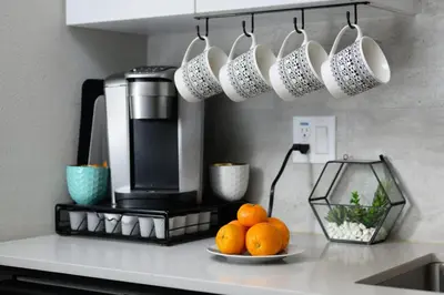 a counter with a plate of oranges and coffee cups at Casa Clementine - 10 min to SNA&Beach Plus Free Parking in Orange