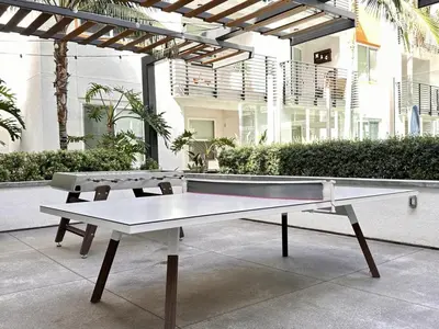 a ping pong table in front of a building at Casa Clementine - 10 min to SNA&Beach Plus Free Parking in Orange