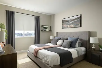 a bedroom with a large bed and a window at The Belladonna at Main Place - Disney Gift Card! in Orange