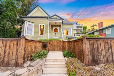 a wooden fence in front of a house at Netflix, Stocked Kitchenette, Beach Gear in Ventura