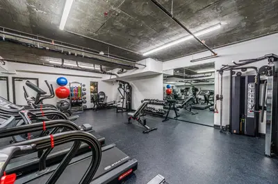 a gym with treadmills and machines in a room at Luxury 1BD Condo in LA with Rooftop City Views, Gym & Free Parking in Los Angeles