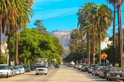 a street with cars parked on the side of a mountain at Luxury 1BD Condo in LA with Rooftop City Views, Gym & Free Parking in Los Angeles
