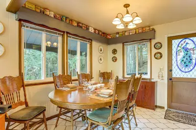 a dining room with a wooden table and chairs at Quiet Home Less Than 1 Mi to Lake Gregory and Dtwn Crestline in Crestline