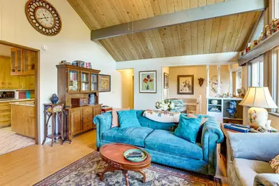 a living room with a blue couch and a table at Quiet Home Less Than 1 Mi to Lake Gregory and Dtwn Crestline in Crestline