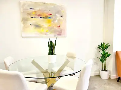 a dining room with a glass table and chairs at The Gallery Spacious 2BD 2BA with Two King Beds in Los Angeles
