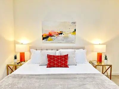 a bedroom with a white bed with two lamps at The Gallery Spacious 2BD 2BA with Two King Beds in Los Angeles