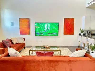 a living room with a couch and a tv at The Gallery Spacious 2BD 2BA with Two King Beds in Los Angeles