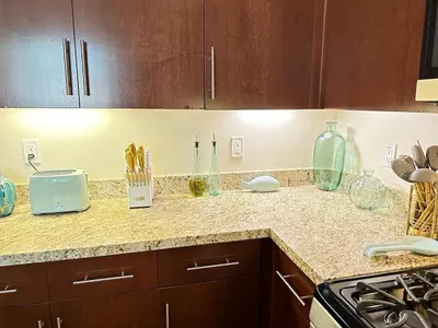 a kitchen counter with glass bottles and utensils on it at 2 King Beds DTSM! Walk to Pier, Promenade & Beach in Los Angeles