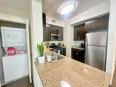 a kitchen with a sink and a stainless steel refrigerator at Spacious 2 BD with 2 King Beds Walk to Pier & Beach in Los Angeles