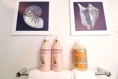 a bathroom with two bottles of soap and pictures at 2 KING BEDS Walk PIER BEACH and 3rd St PROMENADE in Los Angeles