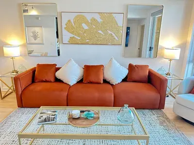 a brown couch in a living room with a table at 5 Star Location with City Views 2BD 2BA with King Beds in Los Angeles