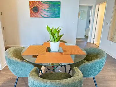 a glass table with chairs and a plant on it at 5 Star Location with Open City Views 2BD 2BA with King Beds in Los Angeles