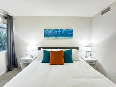 a bedroom with a large white bed with two lamps at 5 Star Location with Open City Views 2BD 2BA with King Beds in Los Angeles