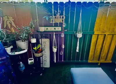 a fence with potted plants and a sign on it at Cozy Beach Haven in Los Angeles