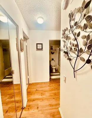 a hallway with a bathroom with a toilet in a room at Cozy Beach Haven in Los Angeles