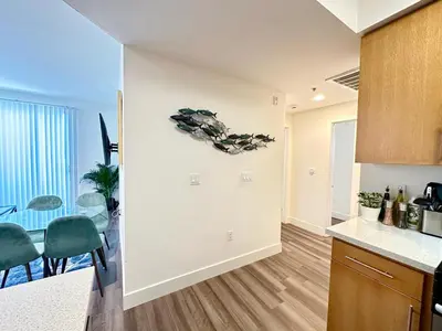 a kitchen and living room with a table and chairs at Bright 2 Bed 2 Bath with Views Walk to the Beach DTSM in Los Angeles