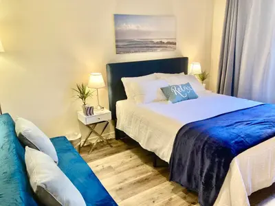 a bedroom with a bed and a couch in it at Fully Equipped DTSM Studio, Blocks to Ocean & Pier in Los Angeles