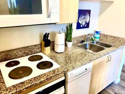 a kitchen counter with a stove and a sink at Heart of DT SM Studio, Walk To Beach & Pier in Los Angeles